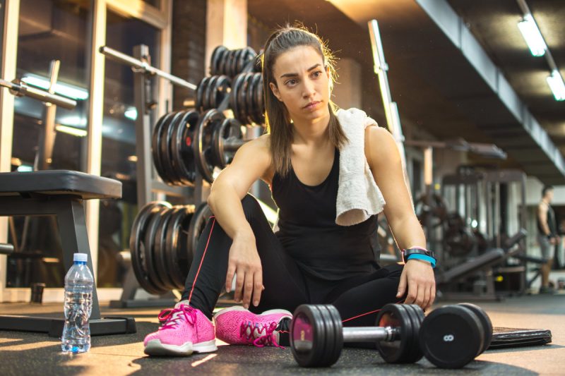 Young woman taking a break in a gym